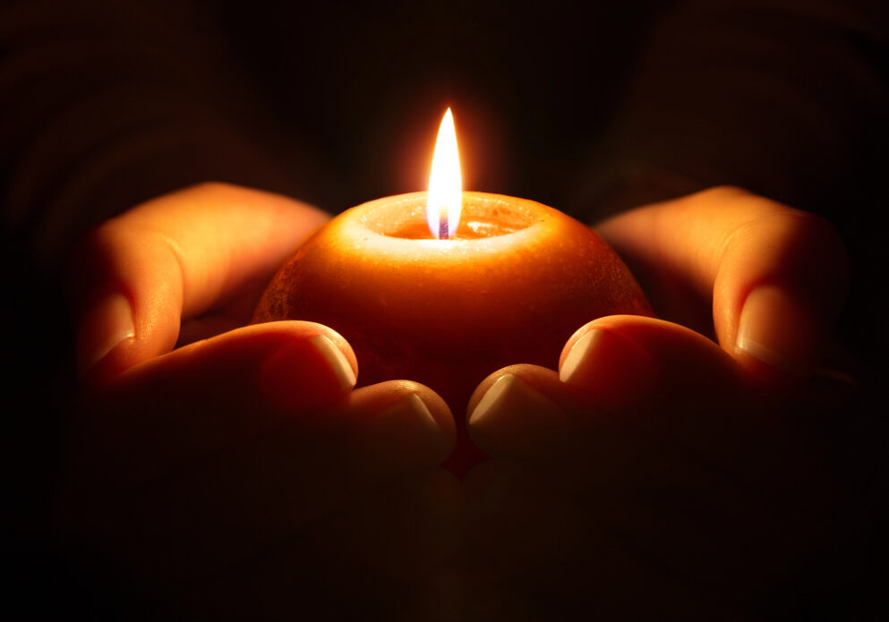 prayer-candle-in-hands-Depositphotos_57491911_S